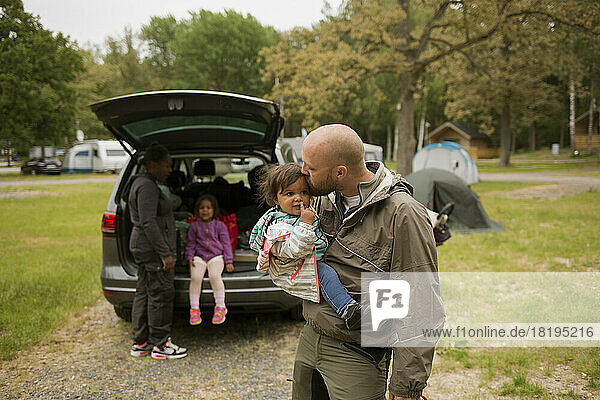 Man with his daughter while camping