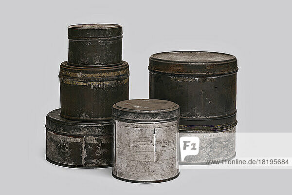 Old paint tins on white background