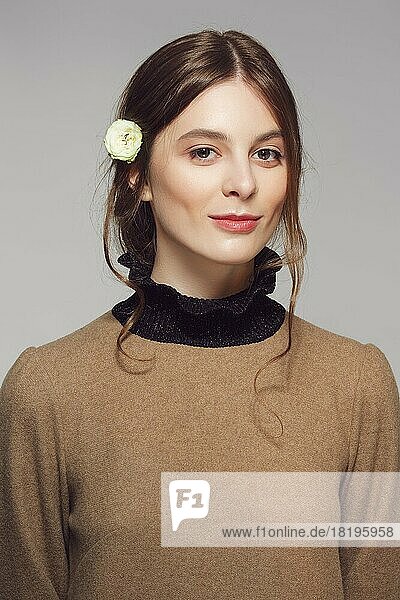 Portrait of a young cute woman in warm wool sweater. Clean pretty face with natural makeup