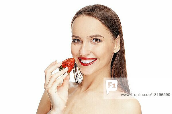 Schöne glückliche Mädchen mit sauberen und frischen Haut essen Erdbeere. Kosmetologie  Behandlung  Schönheit und Spa  Hautpflege und Aromatherapie