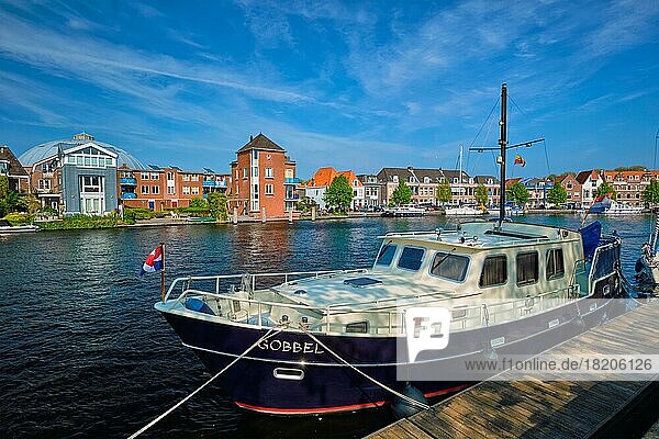 HAARLEM  NETHERLANDS  MAY 6  2018: Spaarne river with boat moorned at quay in Haarlem  Netherlands