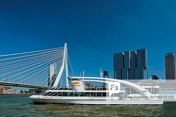 ROTTERDAM  NETHERLANDS  MAY 10  2017: Rotterdam cityscape with Erasmus bridge and ship on Nieuwe Maas river. Rotterdam  Netherlands