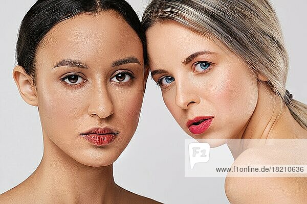 Close up portrait of beautiful caucasian and african young women with different types of skin