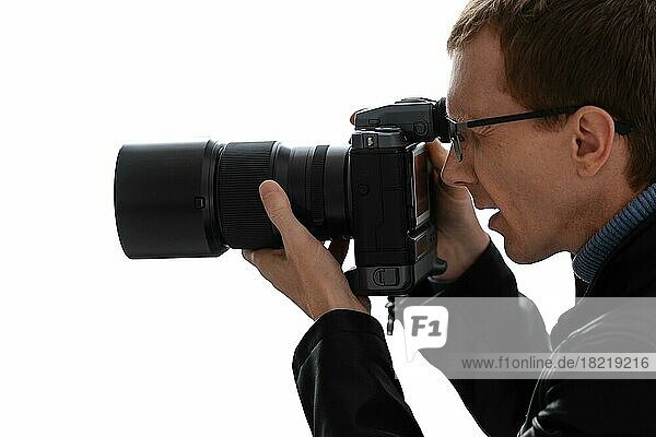 Close up portrait of photographer with camera on white background