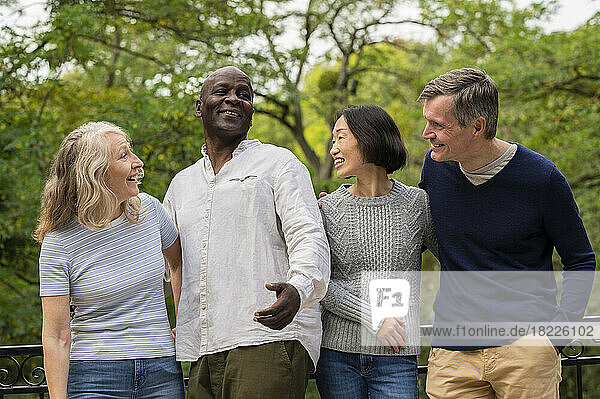 Group of diverse couples enjoying a day out in public park