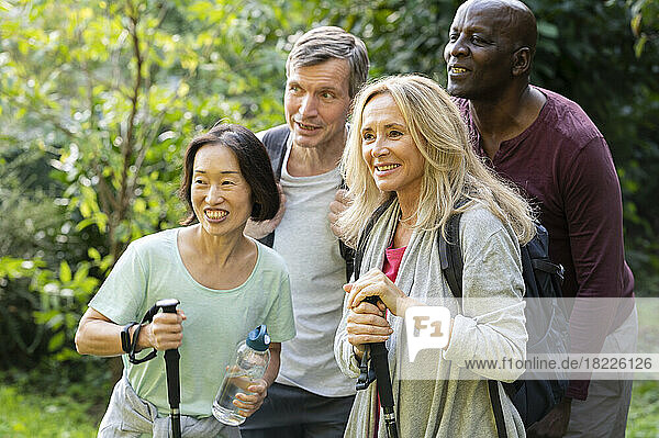 Group of diverse senior friends taking a break in their hike to pose for a photo