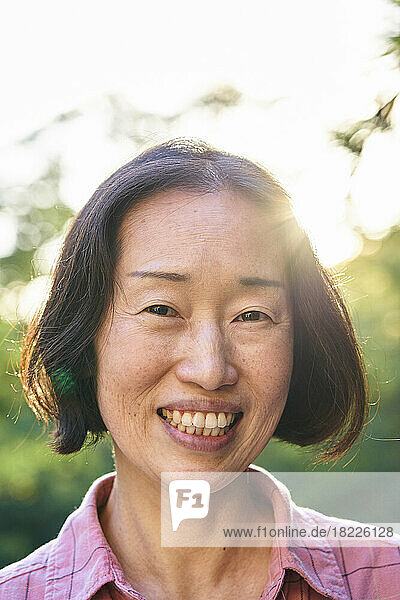 Cheerful senior Asian woman looking at the camera