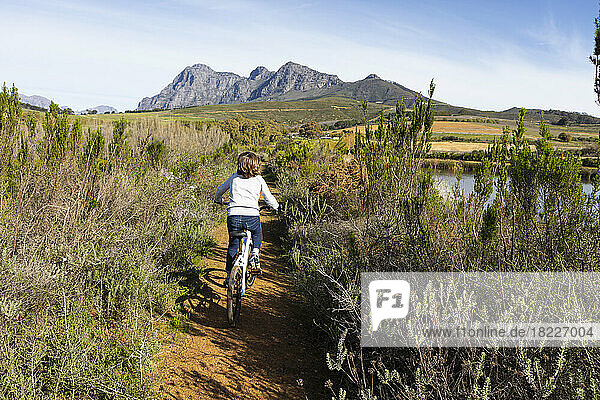 South Africa  Stellenbosch  Rear view of boy (8-9) during bicycle trip