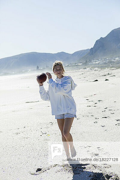 South Africa  Hermanus  Teenage girl (16-17) playing football on beach