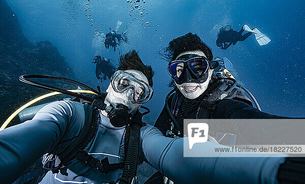 couple taking a selfie underwater at the gulf of Thailand
