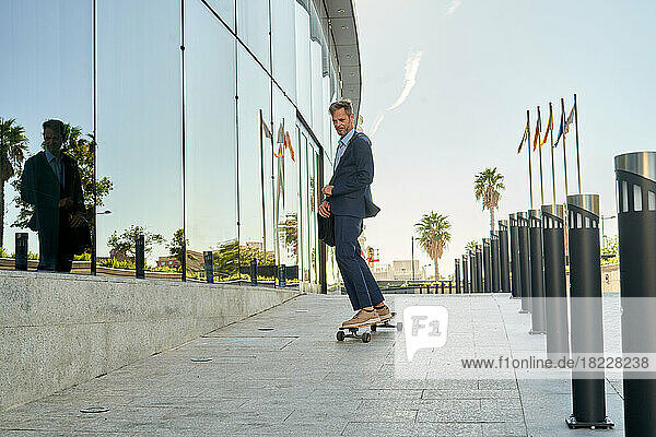 Modern Businessman Going To Work On A Skateboard.