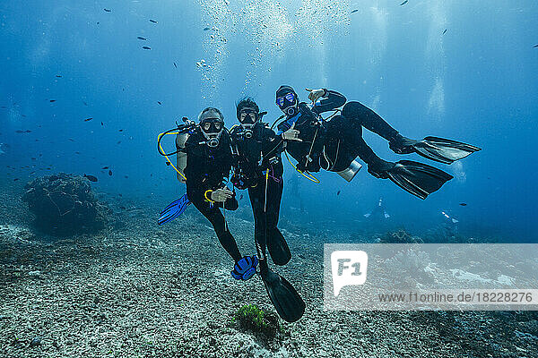 diving buddies posing underwater close to Flores Island in Komodo