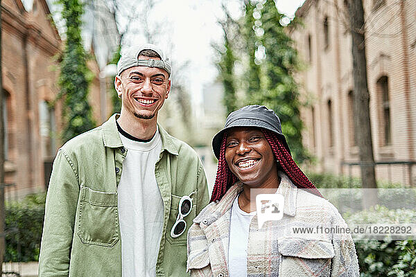 Portrait of happy multiethnic couple on the street