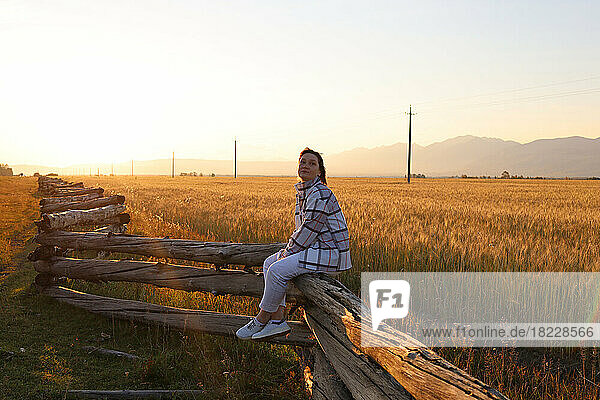 A woman in a field at sunset  Eastern Sayan Mountains  Buryatia