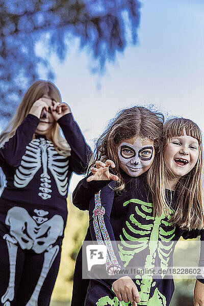 Children celebrating a Halloween costume party in the back garden