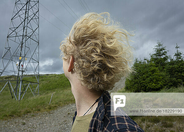 UK  Scotland  Close-up of young blonde man in landscape on windy day