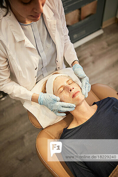 Overhead view of woman having face massage