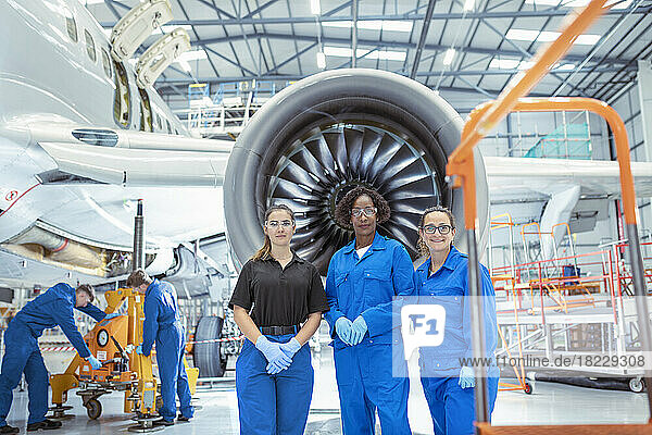Portrait of female aircraft maintenance engineers in aircraft?hangar