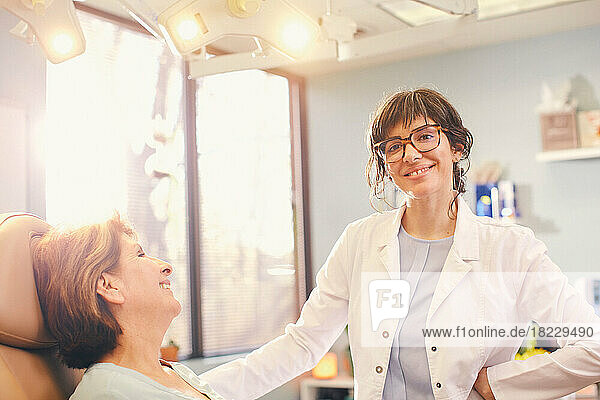 Smiling female doctor?and patient in doctors office