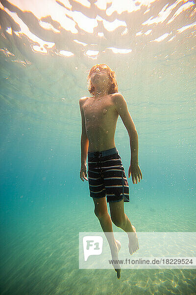 Boy (12-13) swimming underwater