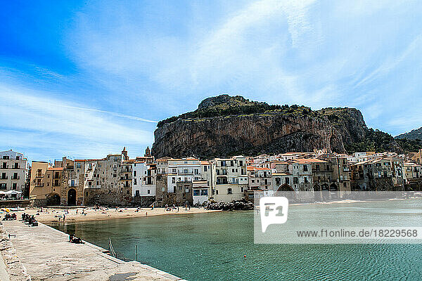 Coastal town with rocky mountain in background  Sicily  Italy