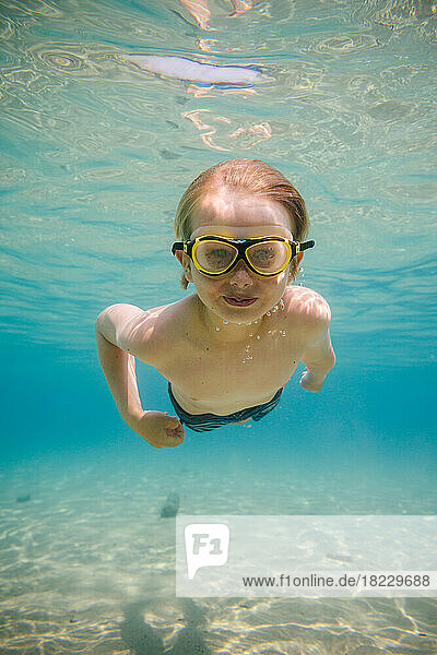 Portrait of boy (8-9) swimming underwater