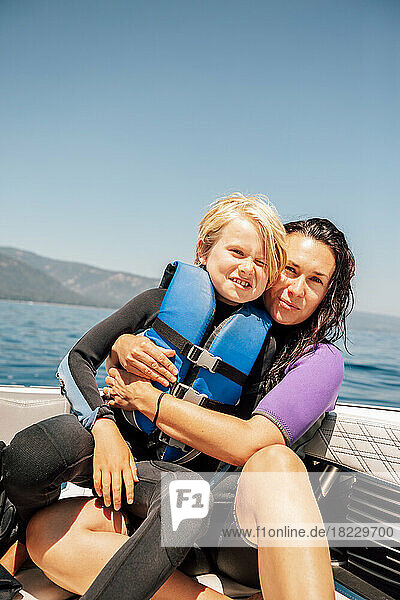 Portrait of mother and son (12-13) on boat