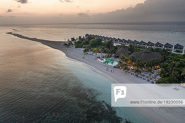 Aerial view of tourist resort and water bungalows at sunset  Maldives