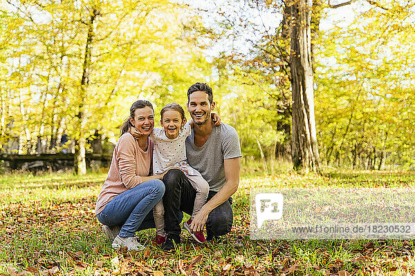 Happy parents with daughter in park