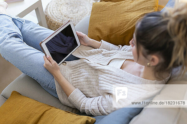 Young woman using smart phone at home