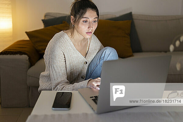 Freelancer working on laptop at night