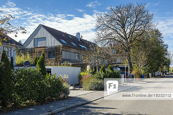 Germany  Bavaria  Munich  Street in front of modern passive house with wooden walls