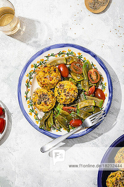 Plate of rice muffins with cherry tomato and green bean salad