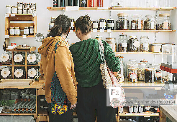 Couple with mesh bags shopping in zero waste store