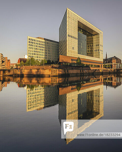 Germany  Hamburg  Office buildings reflecting in Elbe river at dusk