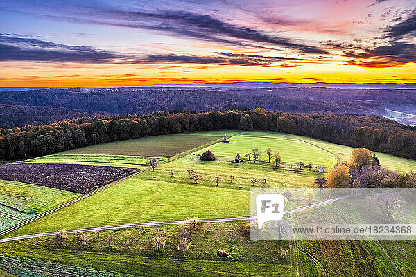 Germany  Baden-Wurttemberg  Drone view of countryside fields in Swabian-Franconian Forest at autumn sunrise