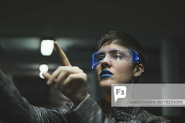 Woman wearing smart glasses gesturing at parking garage