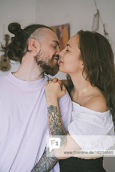 Romantic hipster couple kissing each other