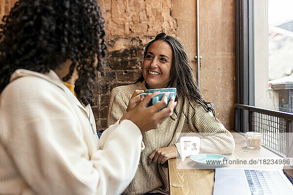 Freelancers enjoying coffee sitting in cafe