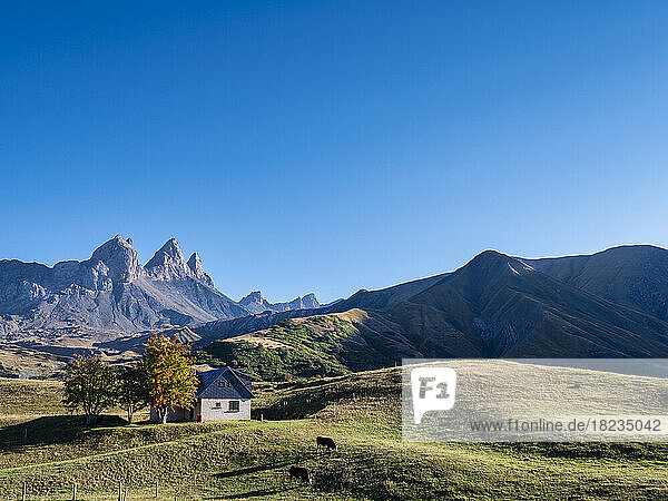 Scenic view of mountains and field under blue sky at Vanoise national park  France
