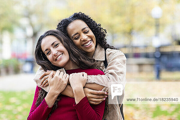 Woman embracing friend in park