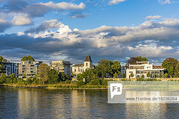 Germany,  Saxony-Anhalt,  Magdeburg,  Clouds over riverside apartments of Werder district