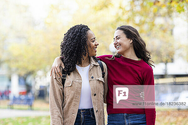 Happy women with arms around in park