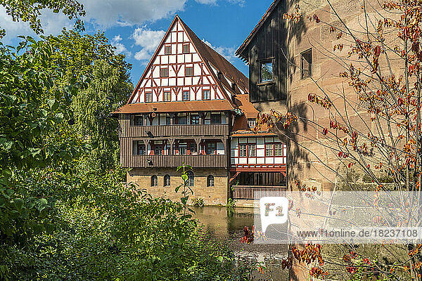 Germany  Bavaria  Nuremberg  Pegnitz river with historic Weinstadel house in background