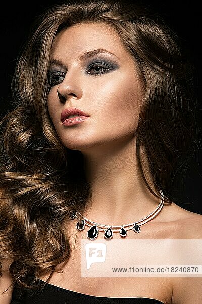 Beautiful woman with evening make-up and long straight hair  Smoky eyes. Fashion photo. Picture taken in the studio on a black background