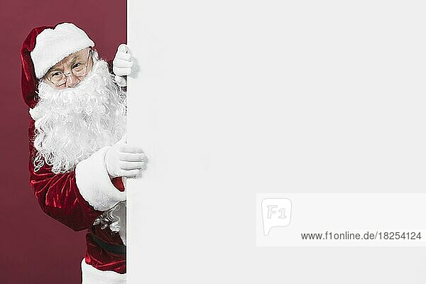 Santa claus looking out white wall  Auflösung und hohe Qualität schönes Foto