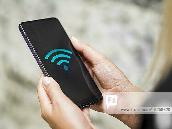 Close up phone hands with wifi symbol