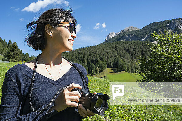 woman taking pictures with digital camera in the Dolomites