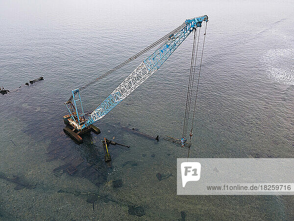 Aerial view of construction crane in ocean