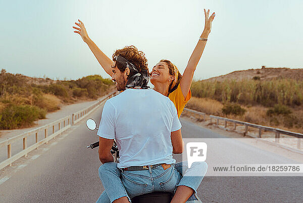 young couple travel happy by motorcycle on the road outdoors.